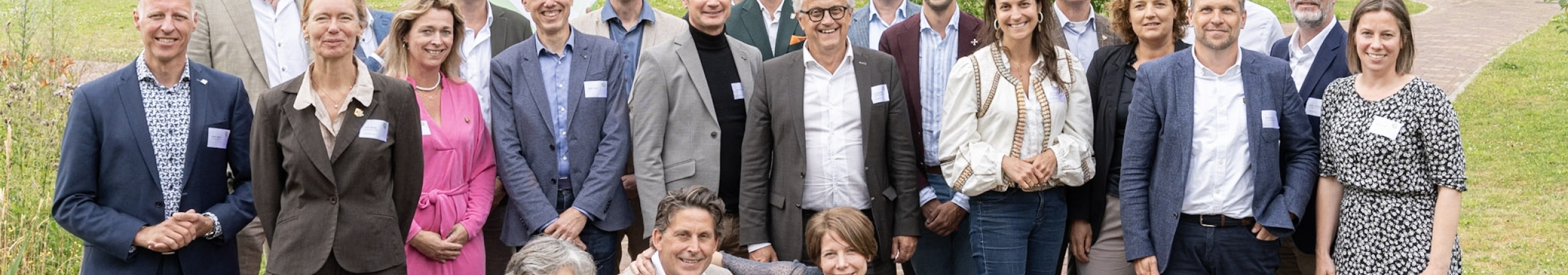 Groep aanwezige  professionals en wethouders staan bij elkaar op de foto